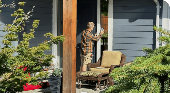 Accessibility image Rick working on home outside with trees surrounding the home