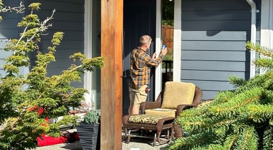 Accessibility image Rick working on home outside with trees surrounding the home