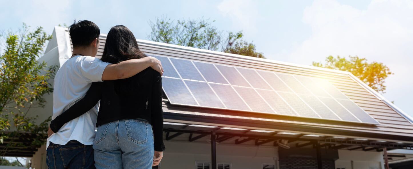 Couple looking at home with solar panels Energy View