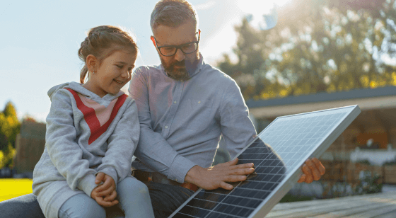 Education image homeowner and daughter looking at solar panels outside of their home