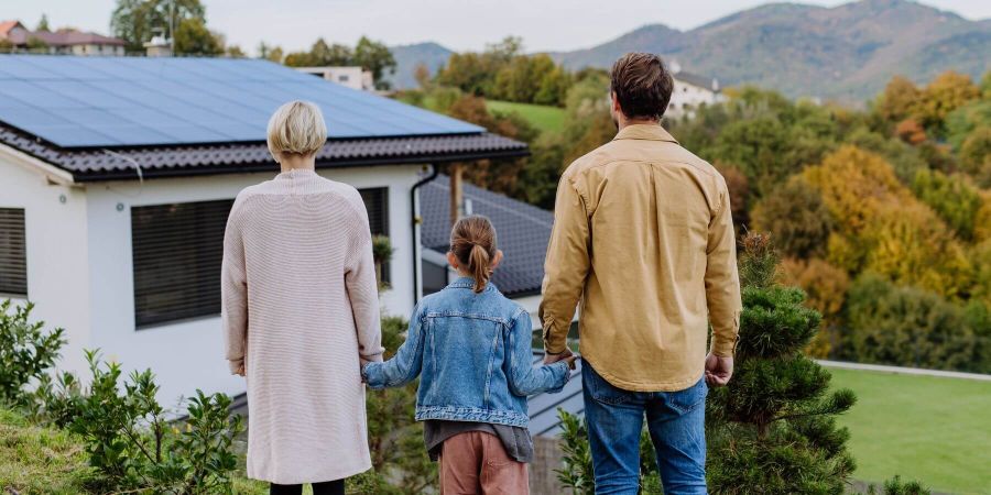 Homeowner family looking at energy efficient home and beautiful view in behind Energy View