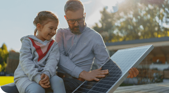 Education image homeowner and daughter looking at solar panels outside of their home